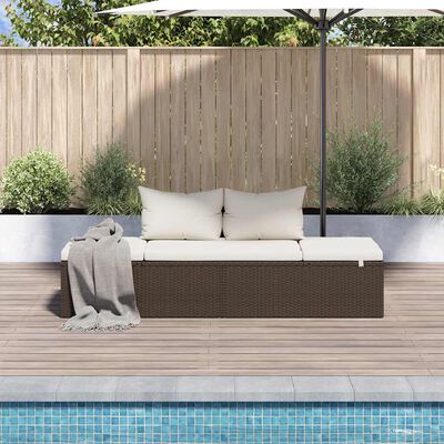 Three-person outdoor wicker sofa with beige cushions and umbrella, poolside.