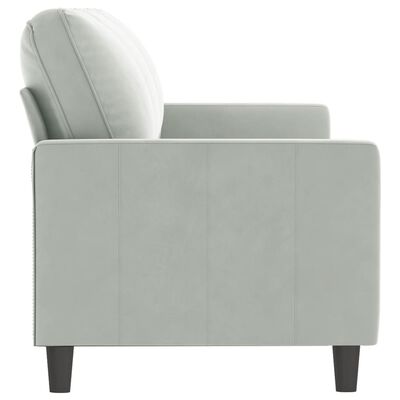 Side view of a light gray armrest sofa showing the right armrest, back cushion, and vertical panel stitching.