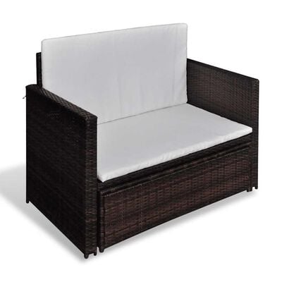 Single brown wicker armchair with white cushions.