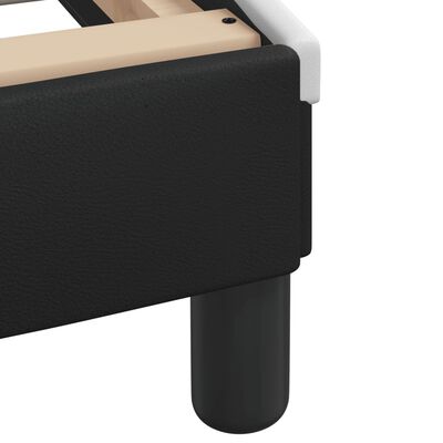 Close-up of black upholstered bed frame corner and leg