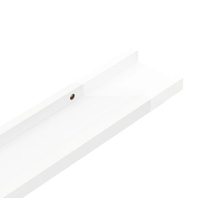 Close-up of a mounting hole on a white shelf rail
