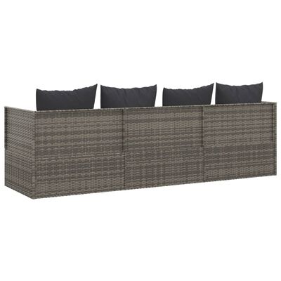 Long sectional outdoor wicker sofa with multiple seat sections and dark cushions.