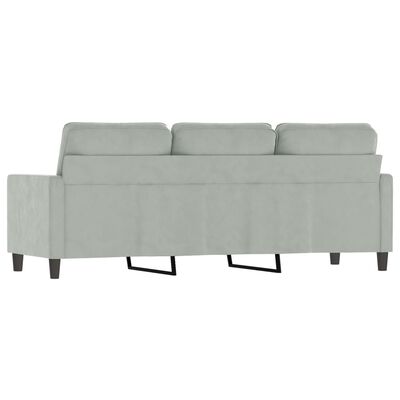 Rear view of a light gray modular sofa showing back cushions and exposed legs, with side arm panels visible.