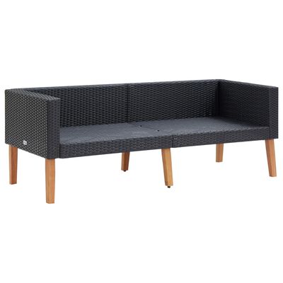 Two-seat dark woven outdoor sofa frame with white cushions and wooden legs.