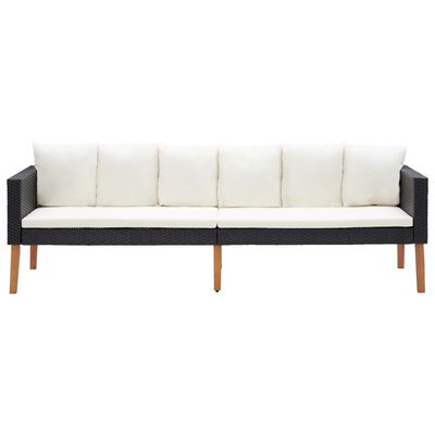 Long dark woven outdoor sofa with white cushions and wooden legs, all on white background.