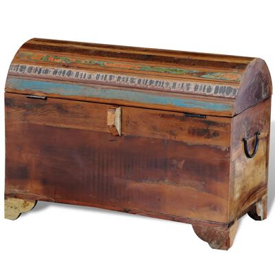 Rear side of a weathered wooden chest with latch and painted decorative band.