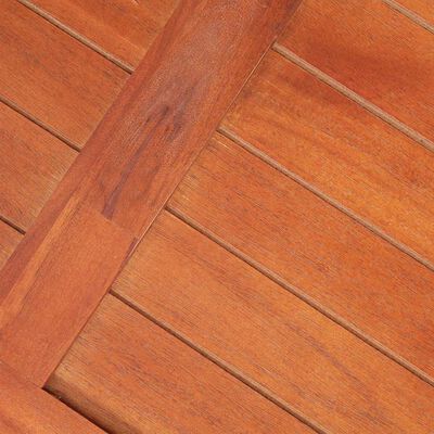 Wooden deck-like surface with diagonal slats forming a pattern.