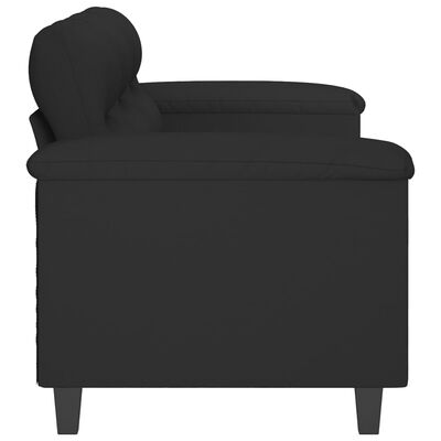 Close-up of the armrest and back cushion of a black sofa displaying the upholstery