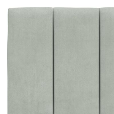 Close-up of vertical panels on headboard showing channel tufting in light gray fabric.