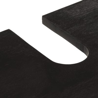 Close-up of a curved cutout or notch in the black furniture piece.