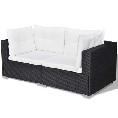 Two-seater outdoor sofa with white cushions and dark wicker frame.