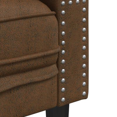 Close-up of brown textured leather-like upholstery with metal studs along edge.