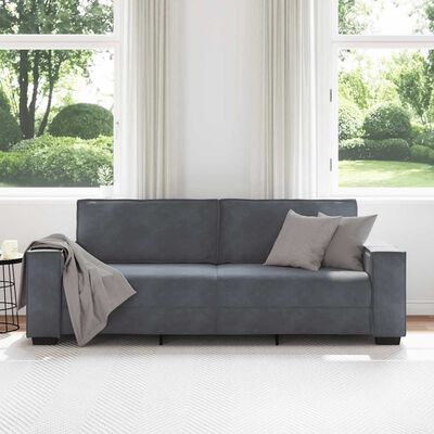 Blue-gray sofa in a bright room, front view of a three-seat sofa with solid cushions and square arms.