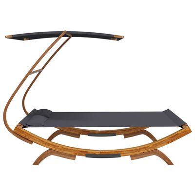 Side angle image of a wooden curved chaise with dark gray fabric and an overhead canopy.