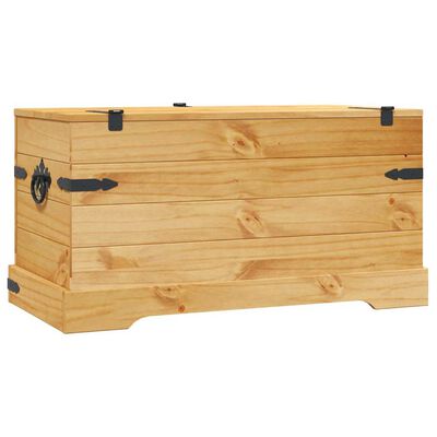 Side view of wooden chest showing decorative corner braces and base molding on a light wood surface.