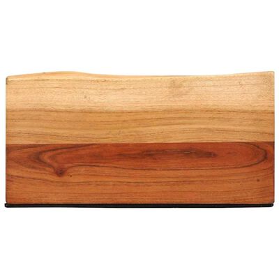 Close-up of wooden block with two-tone wood grain, bottom edge has a black trim.