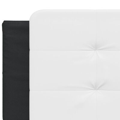 Close-up of white upholstered headboard edge with black frame