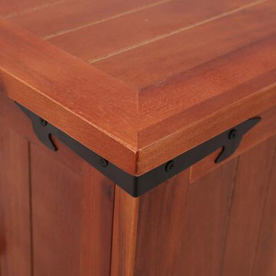 Corner of wooden chest showing black metal decorative hinge and edge