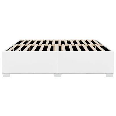 White platform bed with exposed slats on top, headboard not visible