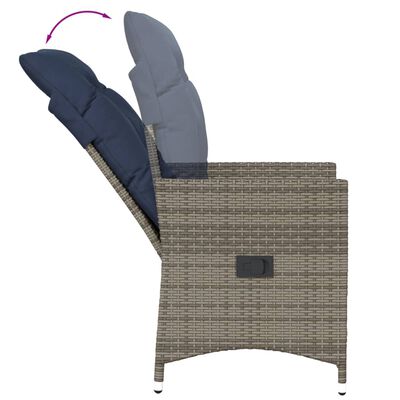 Side view of reclining wicker chair with navy cushions, backrest tilted