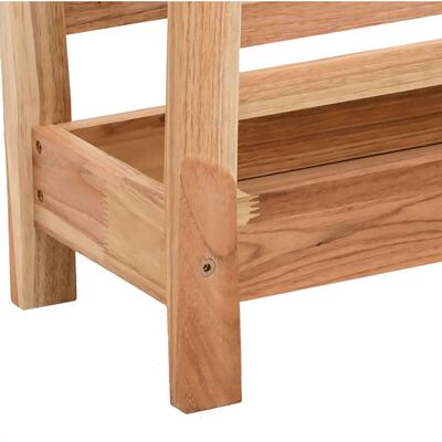 Close-up of bottom corner of wooden rack showing leg joint and storage drawer