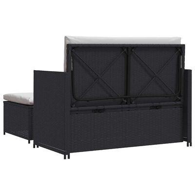 Back view of a dark wicker storage ottoman with lift-up lid and cushions.