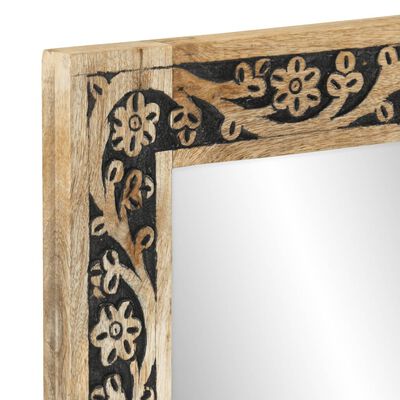 Corner of mirrored frame with ornate floral border