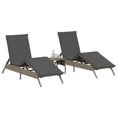 Two gray cushioned lounge chairs with a small table between them.