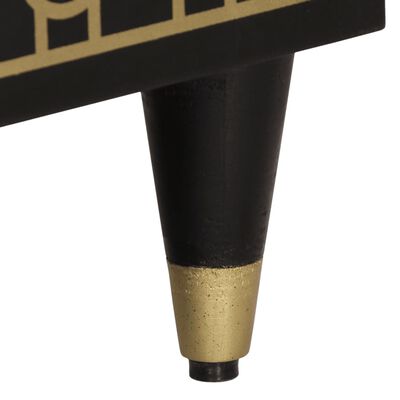 Close-up of a gold metal leg with black base on a furniture piece.