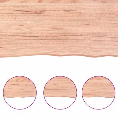 Wooden surface with rounded decorative edge along bottom; three circular insets showing texture
