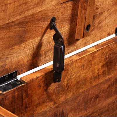 Close-up of the metal hinge attached to the wooden chest