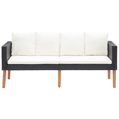 Dark woven outdoor sofa with white cushions and wooden legs.