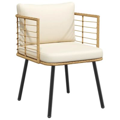 Close-up of one cream cushioned rattan chair with curved arms and black metal legs.