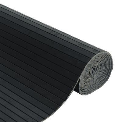 Rolled black ribbed mat or installation mat with gray underside visible at rolled end.