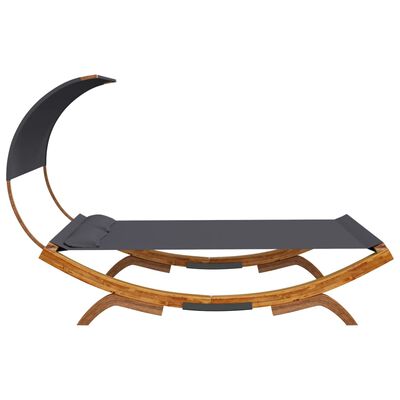 Low-profile daybed with wood arc frame and dark gray mattress; curved wooden base and minimal cushions.