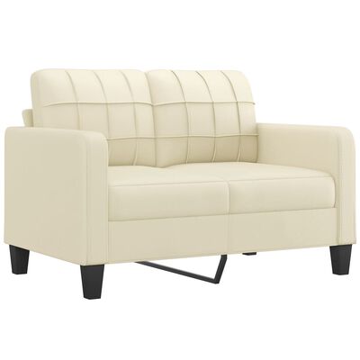 Cream sofa loveseat close-up showing grid-stitched back cushions and tapered black legs.