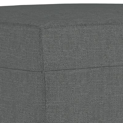 Close-up of corner seam on grey fabric upholstery.