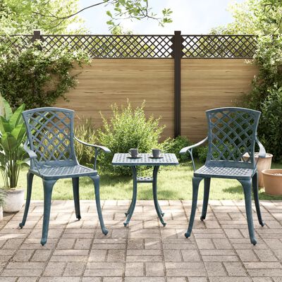 Two lattice-back patio chairs with a small table between them on a tiled patio.