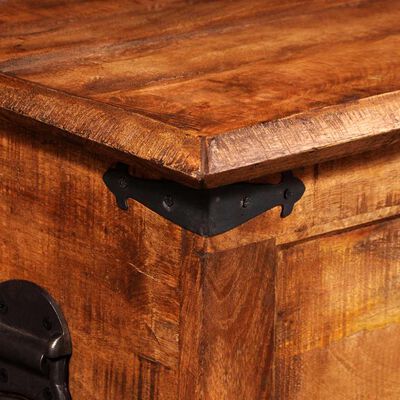 Corner of the wooden chest showing top edge and decorative metal bracket