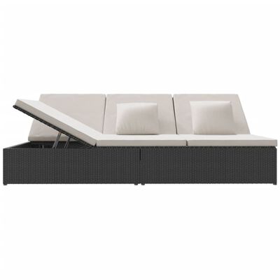 Side view of a dark wicker outdoor sectional with three back cushions and a pull-out canopy/adjustable backrest feature