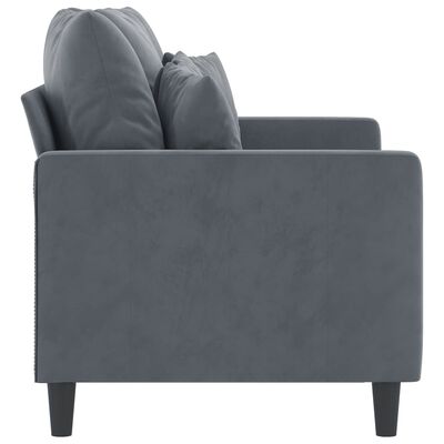 Side view of a grey upholstered sofa showing a low back, two armrests, and short legs.