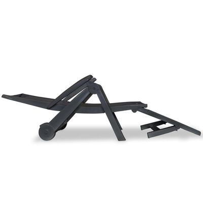 Side profile of a dark gray convertible lounge chair with extendable footrest