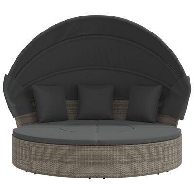 Round outdoor daybed with dark canopy and 4 cushions and two sections forming a circle