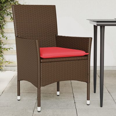 Single brown woven patio chair with red cushion placed beside a table