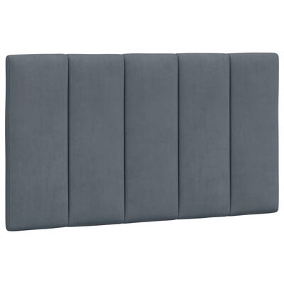 Close-up of tall padded headboard with vertical channels in blue upholstery.
