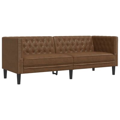 Close-up of a brown tufted sofa with nailhead trim along the arm.