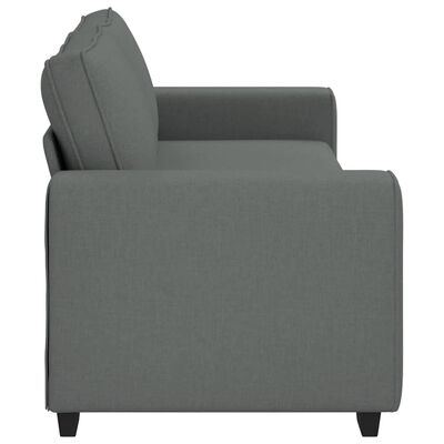 Side view close-up of the armrest and seat cushion of a grey fabric sofa.