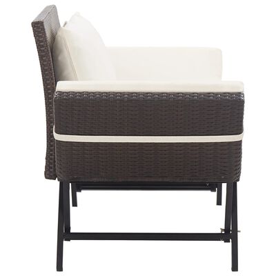Side view of brown wicker armchair with cream cushions and metal frame