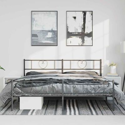 Bedroom setup with two single beds pushed together under similar heart-accented headboards, framed art above.