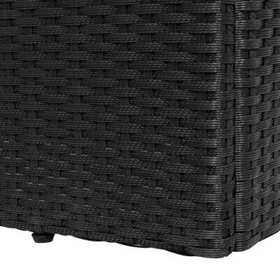 Close-up detail of black woven rattan texture on a furniture piece.